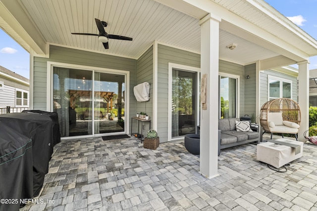 view of patio / terrace with a ceiling fan and an outdoor living space