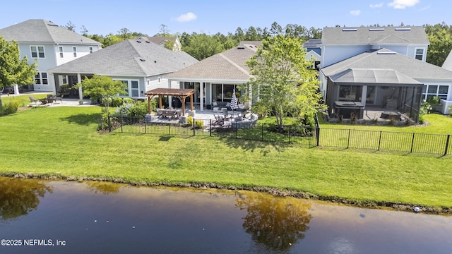 back of property with a patio area, a water view, and glass enclosure