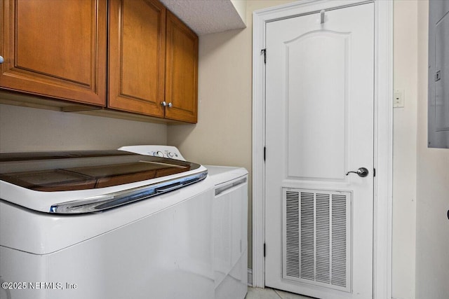 washroom featuring separate washer and dryer and cabinet space