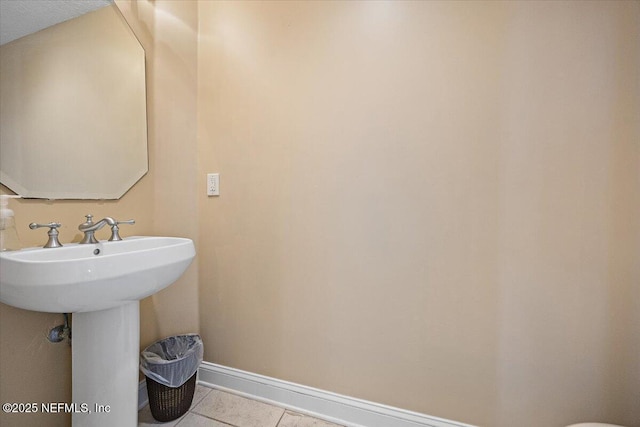 bathroom featuring baseboards and tile patterned flooring