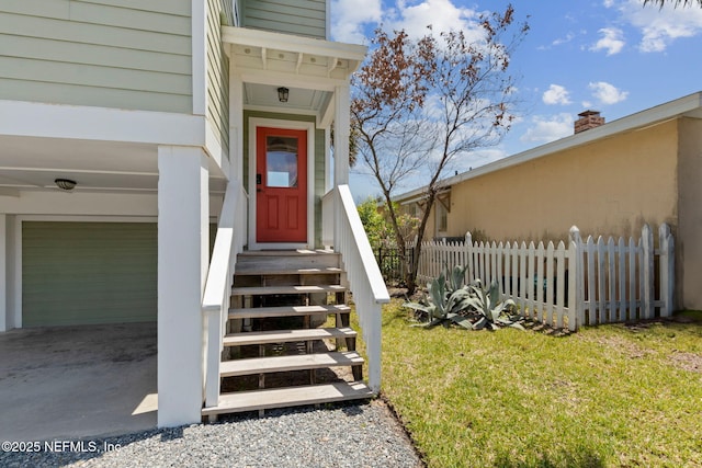 doorway to property featuring a yard, fence, a chimney, and a garage