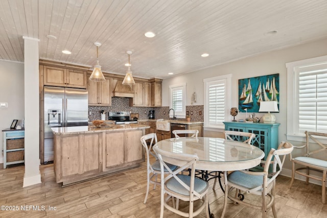 dining room with recessed lighting, wooden ceiling, and light wood finished floors