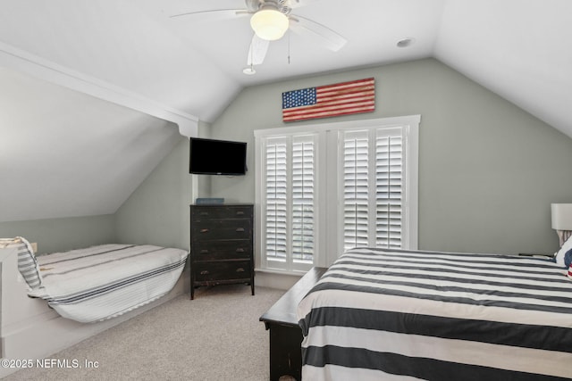 carpeted bedroom with a ceiling fan and lofted ceiling