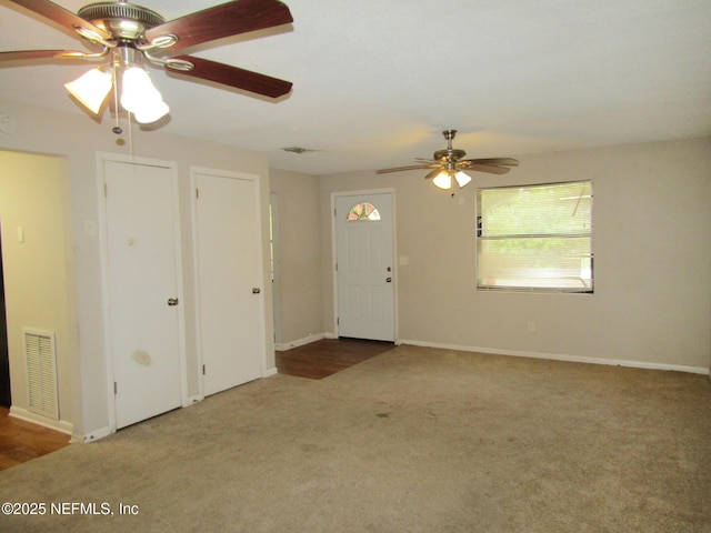 unfurnished living room featuring carpet floors, ceiling fan, baseboards, and visible vents