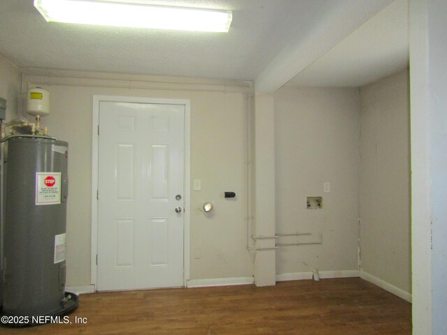 interior space featuring baseboards, wood finished floors, and water heater