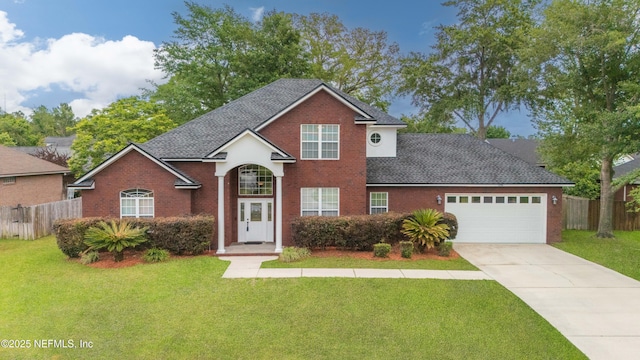 1296 Copper Creek Dr, Macclenny, FL 32063 - traditional-style house with a garage, fence, a front lawn, brick siding, and driveway