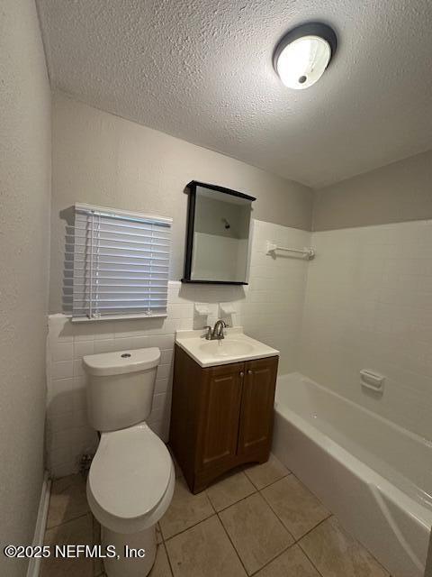 3262 Dignan St, Jacksonville, FL 32254 - full bathroom featuring tile patterned flooring, vanity, toilet, a textured ceiling, and  shower combination