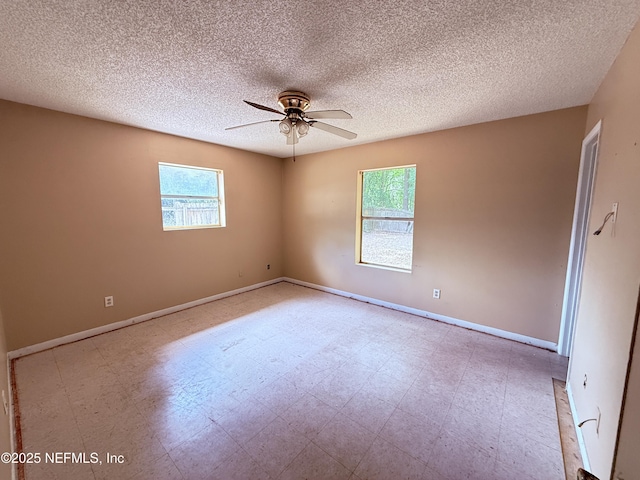4503 Royal St, Palatka, FL 32177 - empty room with baseboards, ceiling fan, tile patterned floors, and a textured ceiling