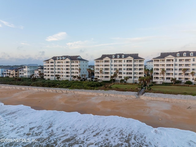 view of property featuring view of water and beach