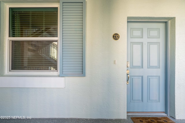 doorway to property with stucco siding