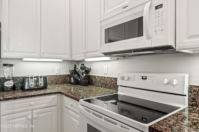 kitchen featuring white appliances and white cabinets