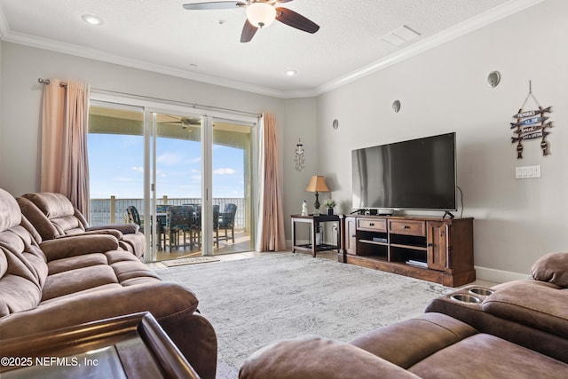 living room featuring a ceiling fan, a textured ceiling, ornamental molding, baseboards, and recessed lighting