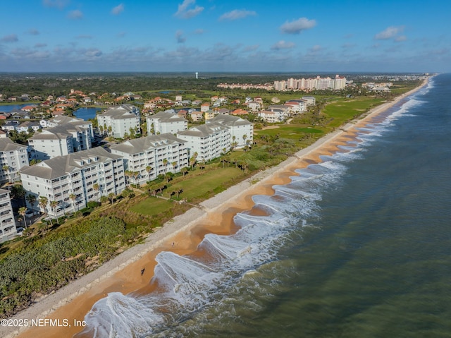bird's eye view of expansive coastline and apartment complex