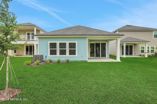 37 Bird Watch Ct, Saint Augustine, FL 32092 - back of property featuring central air condition unit, a lawn, a patio area, and roof with shingles