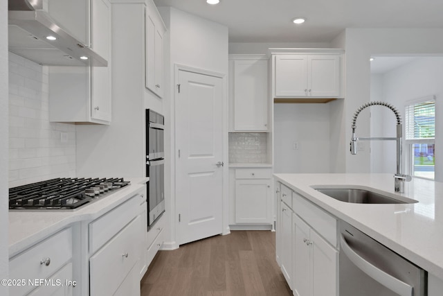 37 Bird Watch Ct, Saint Augustine, FL 32092 - kitchen featuring stainless steel appliances, a sink, wall chimney range hood, tasteful backsplash, and recessed lighting