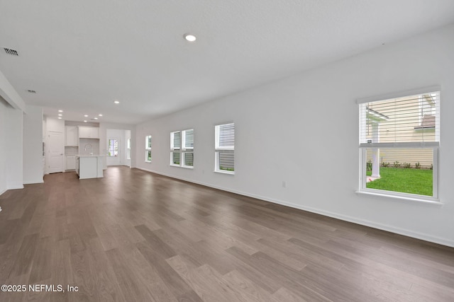 37 Bird Watch Ct, Saint Augustine, FL 32092 - unfurnished living room with healthy amount of natural light, wood finished floors, baseboards, and recessed lighting