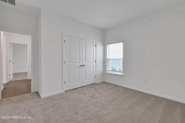 37 Bird Watch Ct, Saint Augustine, FL 32092 - unfurnished bedroom with carpet, baseboards, and a closet