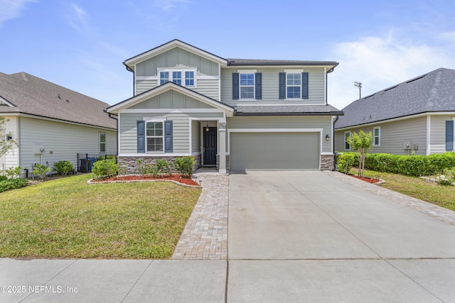 513 Sandstone Dr, Saint Augustine, FL 32086 - view of front of home featuring board and batten siding, driveway, a front yard, a garage, and stone siding
