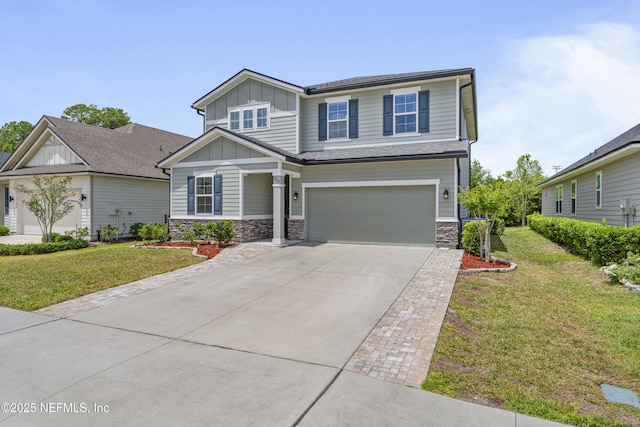 513 Sandstone Dr, Saint Augustine, FL 32086 - view of front facade featuring a garage, a front lawn, stone siding, board and batten siding, and concrete driveway