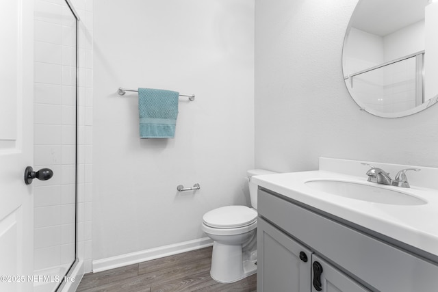 513 Sandstone Dr, Saint Augustine, FL 32086 - full bathroom with a tile shower, vanity, toilet, baseboards, and wood finished floors