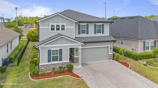 513 Sandstone Dr, Saint Augustine, FL 32086 - view of front of home with roof with shingles, fence, board and batten siding, and an attached garage