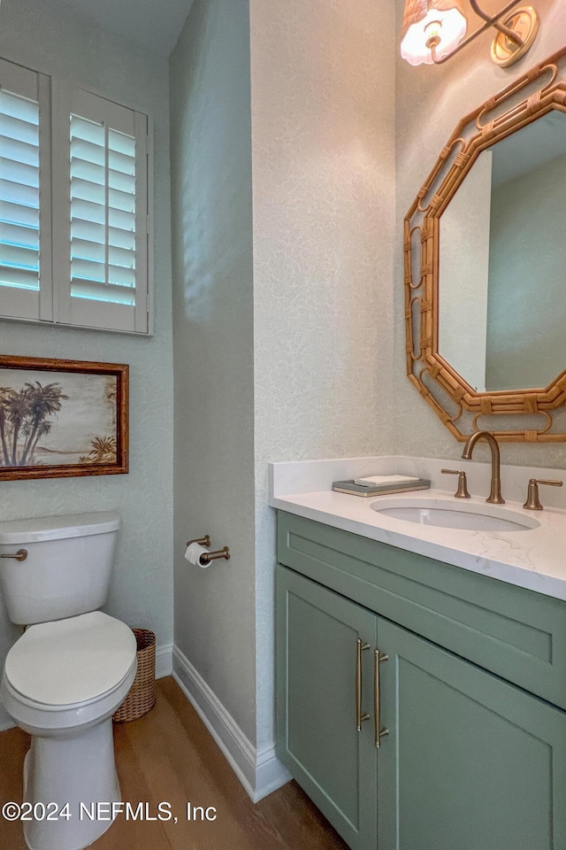 128 Sutton Dr, Ponte Vedra, FL 32081 - half bathroom with vanity, toilet, wood finished floors, and baseboards
