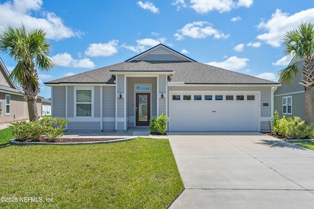 79 Dovetail Cir, Saint Augustine, FL 32095 - view of front of home with driveway, a shingled roof, a front yard, and a garage