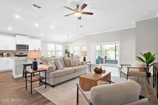 79 Dovetail Cir, Saint Augustine, FL 32095 - living area featuring visible vents, vaulted ceiling, wood finished floors, ornamental molding, and recessed lighting