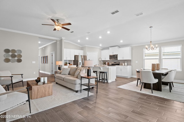 79 Dovetail Cir, Saint Augustine, FL 32095 - living room featuring crown molding, lofted ceiling, and visible vents