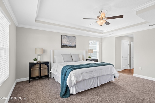 79 Dovetail Cir, Saint Augustine, FL 32095 - carpeted bedroom featuring crown molding, baseboards, ceiling fan, and a tray ceiling