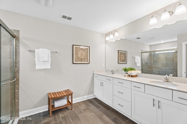 79 Dovetail Cir, Saint Augustine, FL 32095 - bathroom with visible vents, a sink, double vanity, and a shower stall