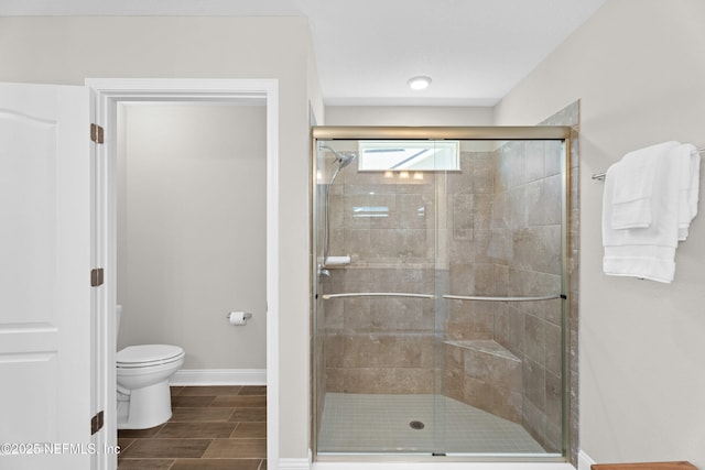 79 Dovetail Cir, Saint Augustine, FL 32095 - full bath featuring baseboards, wood tiled floor, a stall shower, and toilet
