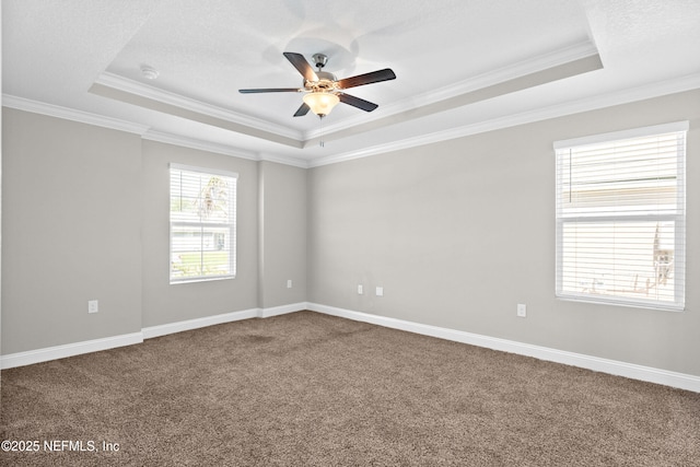79 Dovetail Cir, Saint Augustine, FL 32095 - spare room with crown molding, ceiling fan, a raised ceiling, dark colored carpet, and baseboards