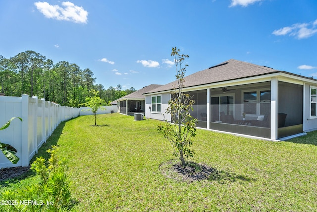 79 Dovetail Cir, Saint Augustine, FL 32095 - back of house with a ceiling fan, roof with shingles, a sunroom, a fenced backyard, and a yard