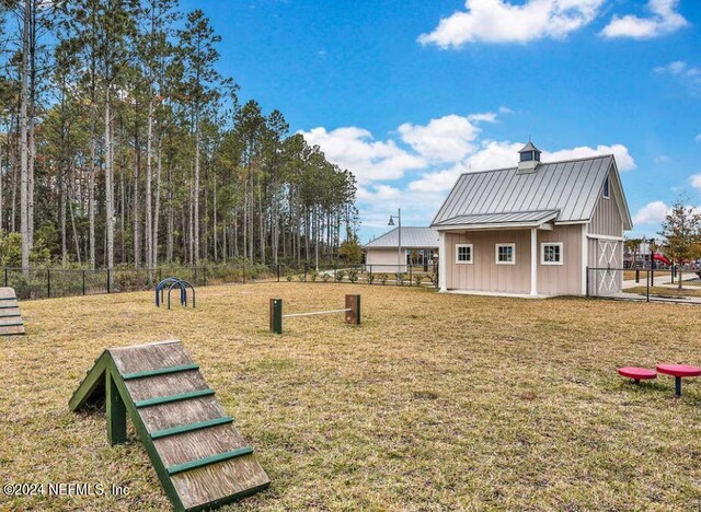exterior space with a lawn and fence