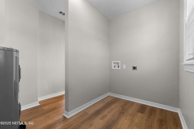 1573 W 16th St, Jacksonville, FL 32209 - washroom with baseboards, hookup for an electric dryer, hookup for a washing machine, and wood finished floors