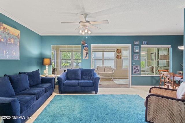 living room with crown molding, a ceiling fan, and tile patterned floors