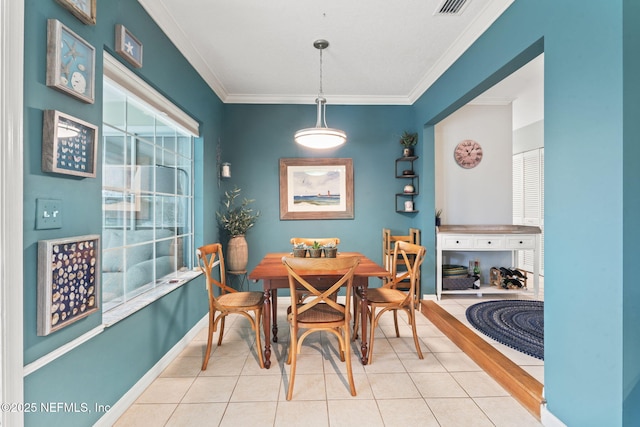 dining space with crown molding, baseboards, and tile patterned floors
