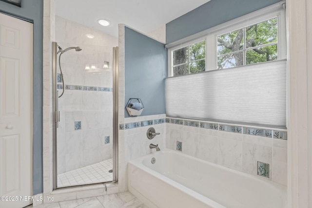 full bathroom with a stall shower, a bath, and marble finish floor