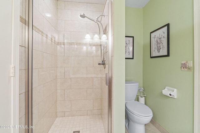 full bathroom with baseboards, toilet, and a shower stall