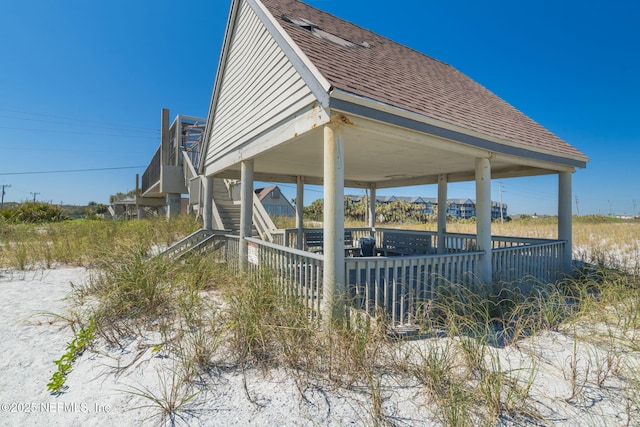 view of property exterior featuring a gazebo and a shingled roof