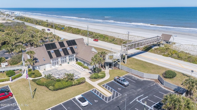 drone / aerial view with a water view and a beach view