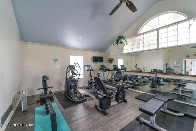 gym with visible vents, wood finished floors, baseboards, ceiling fan, and high vaulted ceiling