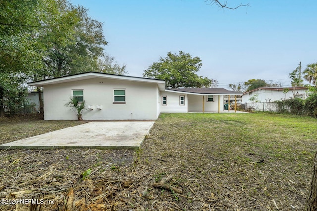 10856 Hawaii Dr S, Jacksonville, FL 32246 - rear view of property with a lawn, a patio area, fence, and stucco siding