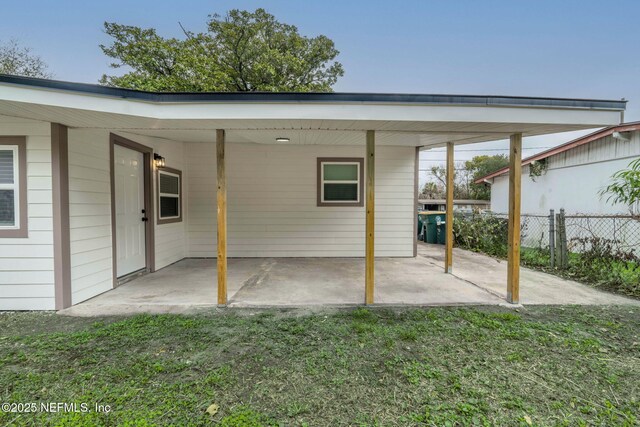 10856 Hawaii Dr S, Jacksonville, FL 32246 - exterior space featuring a lawn, fence, and an attached carport