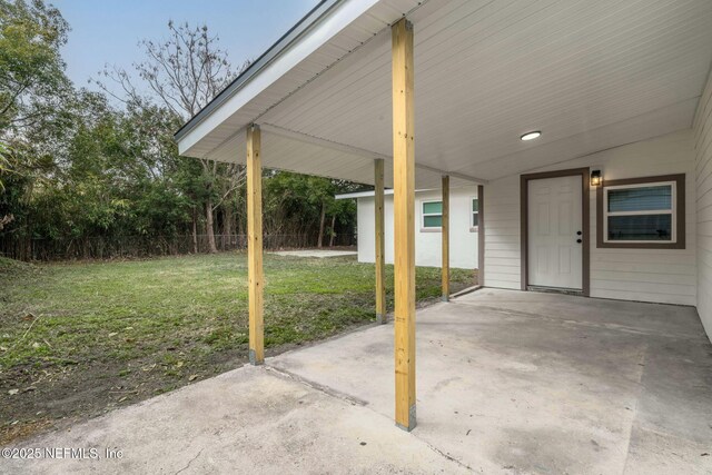10856 Hawaii Dr S, Jacksonville, FL 32246 - view of patio / terrace with fence and a carport