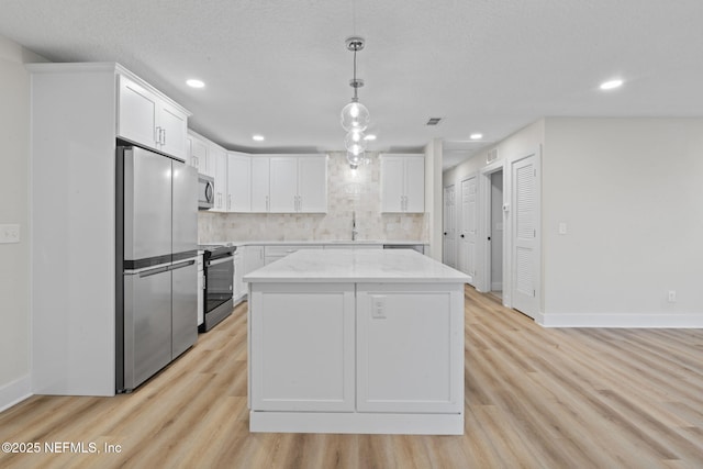 10856 Hawaii Dr S, Jacksonville, FL 32246 - kitchen with white cabinets, baseboards, and appliances with stainless steel finishes