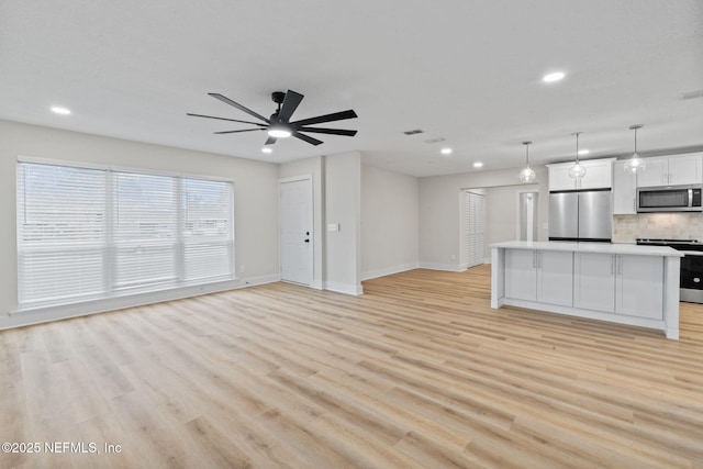10856 Hawaii Dr S, Jacksonville, FL 32246 - unfurnished living room with recessed lighting, a ceiling fan, baseboards, and light wood finished floors