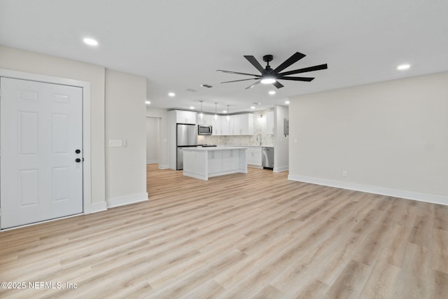 10856 Hawaii Dr S, Jacksonville, FL 32246 - unfurnished living room with recessed lighting, baseboards, and light wood-type flooring