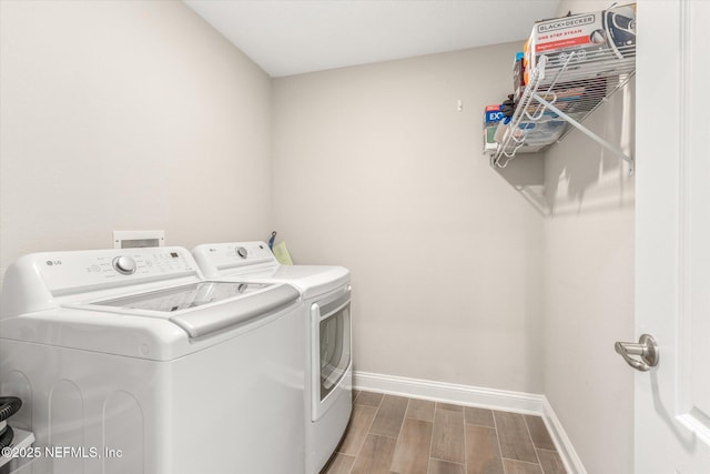 53 Dovetail Cir, Saint Augustine, FL 32095 - laundry room featuring separate washer and dryer, baseboards, laundry area, and wood finish floors